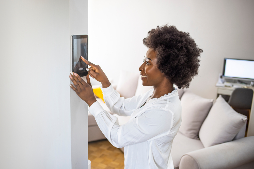 young,african,girl,woman,lady,adjusting,remote,climate,control,panel
