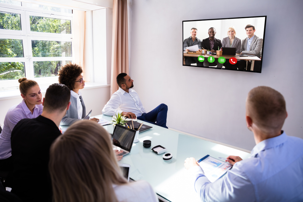 group,of,skillful,businesspeople,video,conferencing,in,boardroom