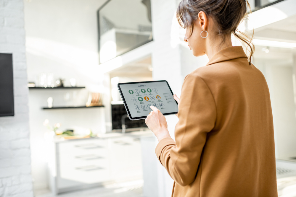 woman,controlling,smart,home,devices,using,a,digital,tablet,with